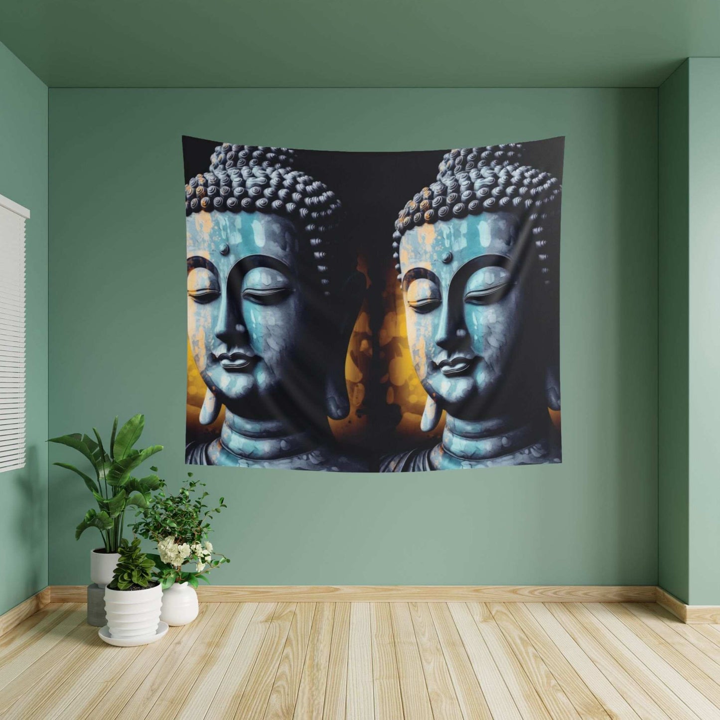 A green room with a wooden floor showcases the Blue Buddha Indoor Wall Tapestry by Printify, illustrating two statues side by side. To the left on the floor, a small plant in a white pot introduces a natural element to enhance the serenity of the meditation space.