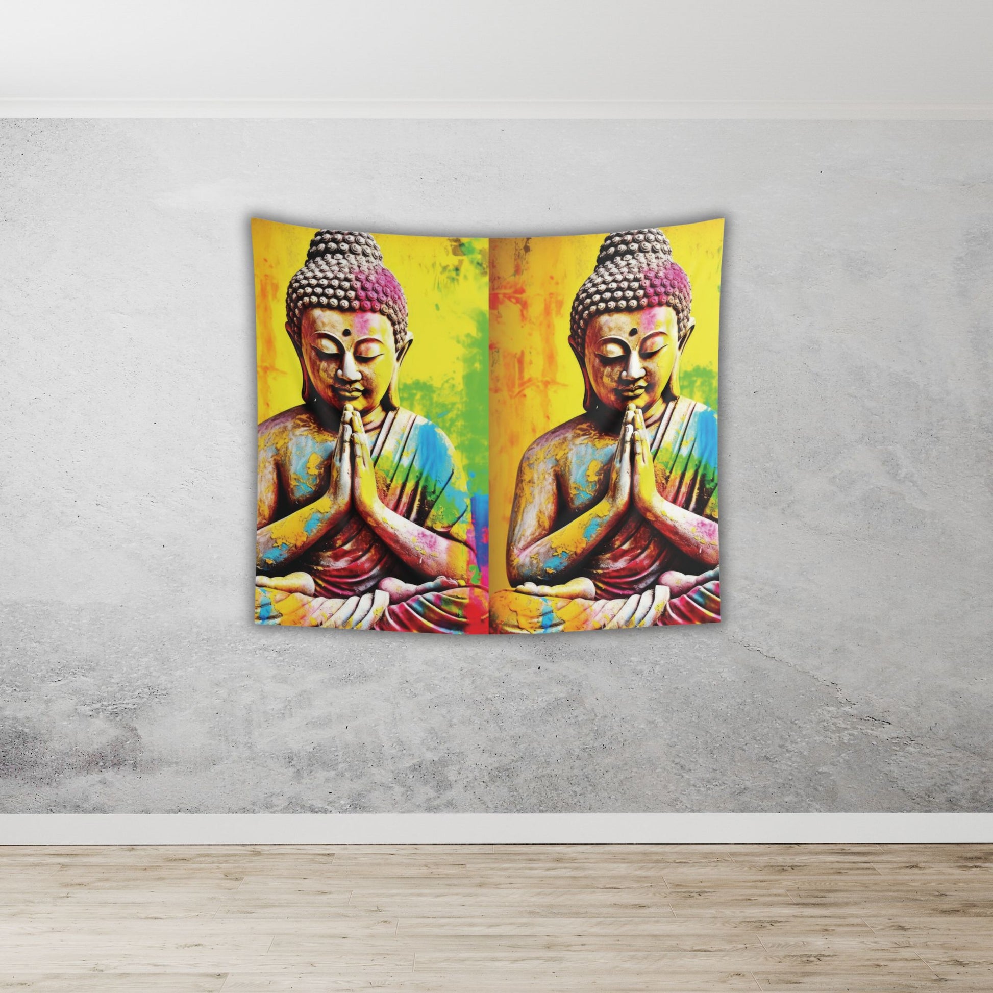 A vibrant Colorful Buddha Tapestry from Printify adorns the wall, featuring two mirrored statues in a praying pose. Perfect for meditation rooms or yoga studios, it showcases bright colors like yellow, pink, and green against a gray wall, complementing the room's light wooden floor.