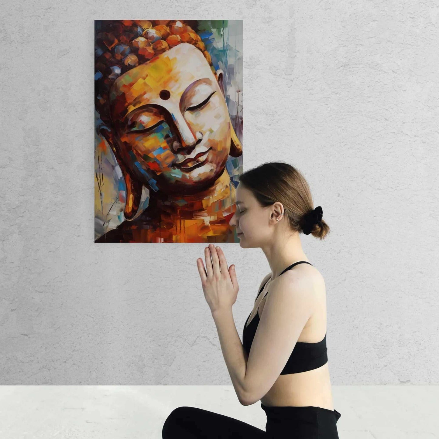 Woman in a black outfit engaging in peaceful meditation in front of an abstract, colorful Buddha portrait, symbolizing inner calm and spirituality.