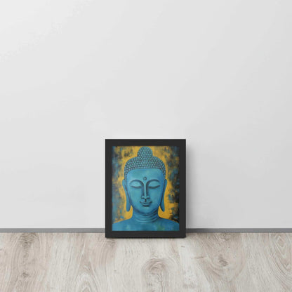 A black oak framed poster displays a Blue Buddha Healing Tibetan Art against a golden yellow background with dark, leaf-like impressions, creating a serene and contemplative artwork, propped on a light wooden floor against a white wall.