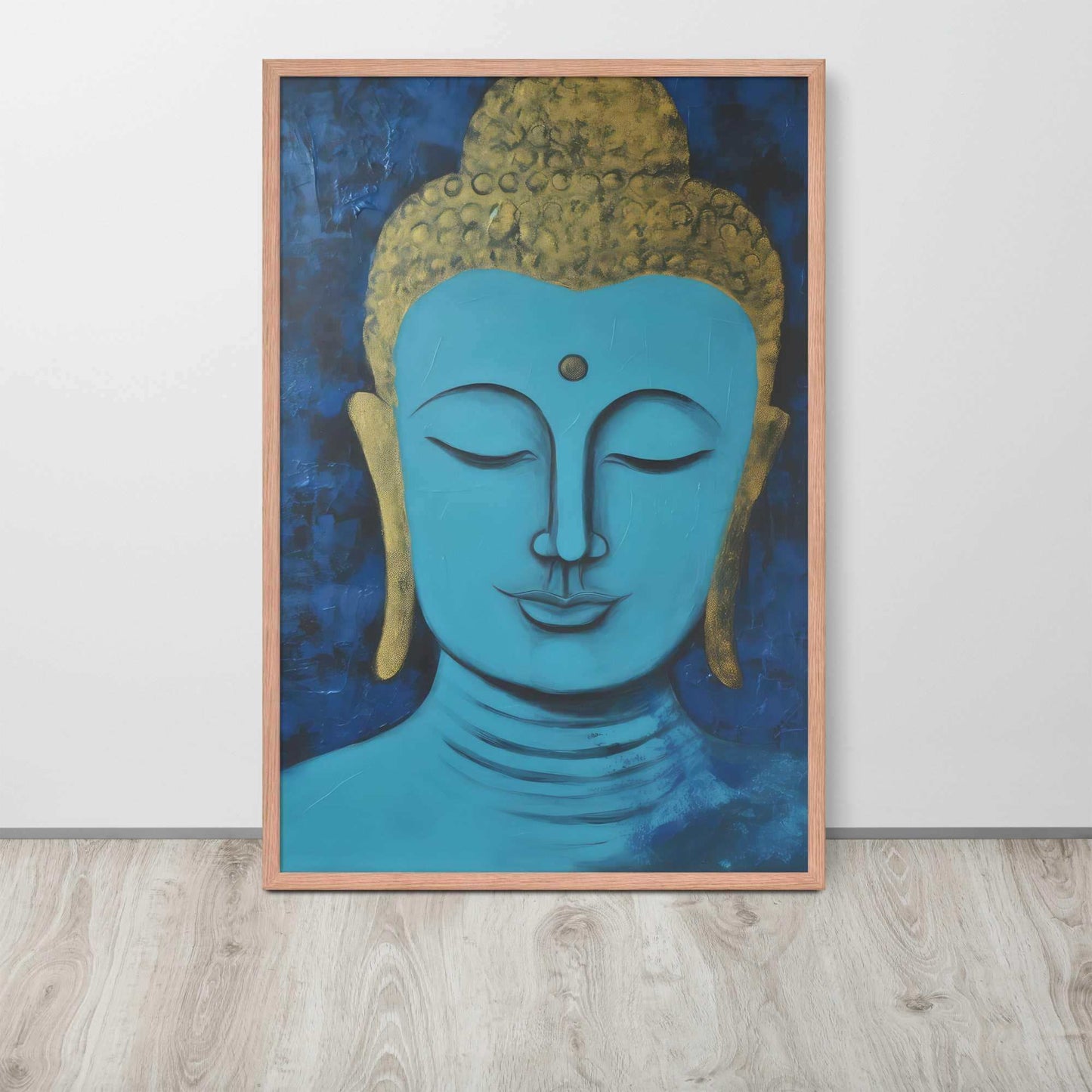 A framed poster with a red oak finish features a serene Blue Buddha Zen Wall Art with golden touches, set against a darker blue backdrop with a rich, textural finish, positioned on a light wooden floor by a plain white wall.