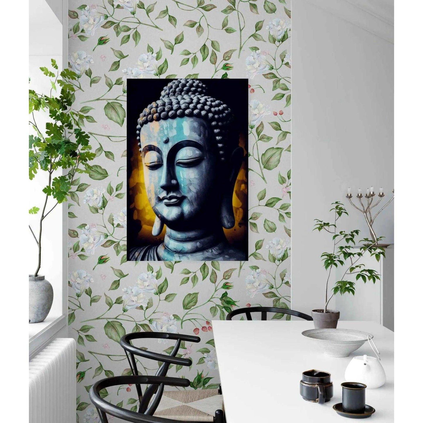 Grayscale Buddha portrait against a yellow bokeh backdrop, centered on a wall with botanical wallpaper, enhancing the calm ambiance of a dining area.