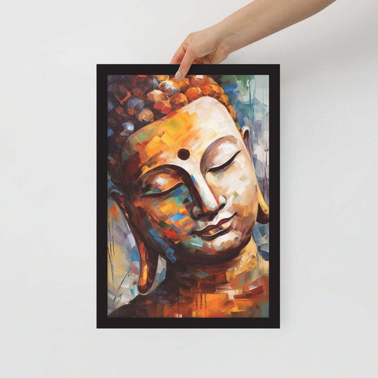 A hand is holding up a black-framed poster featuring an artistic, colorful Buddha face with warm hues and expressive brushstrokes against a white background, creating a striking piece of modern spiritual art.
