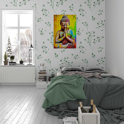 A serene bedroom setting with a bright, artistic Buddha painting on a wall with leaf-patterned wallpaper, alongside a bed with gray bedding and a crate of books and wine bottles.