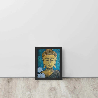 A golden Buddha Painting portrait with a serene expression is framed in black oak, set against a deep blue floral backdrop, placed on a light wooden floor by a white wall. This artwork merges spiritual iconography with a natural motif.