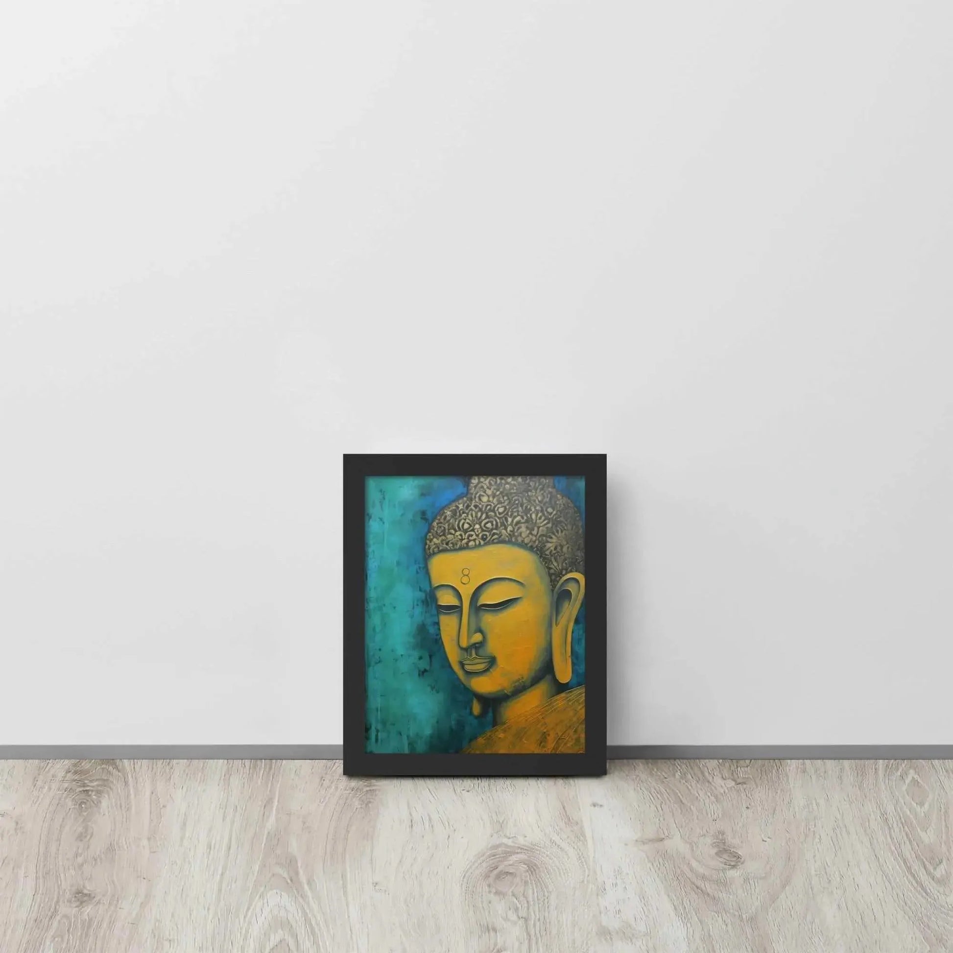 A black oak framed Golden Buddha Painting poster featuring a close-up of a serene Buddha's face with a golden complexion against a textured turquoise background is presented on a light wooden floor beside a white wall, embodying a blend of spirituality and modern art aesthetics.