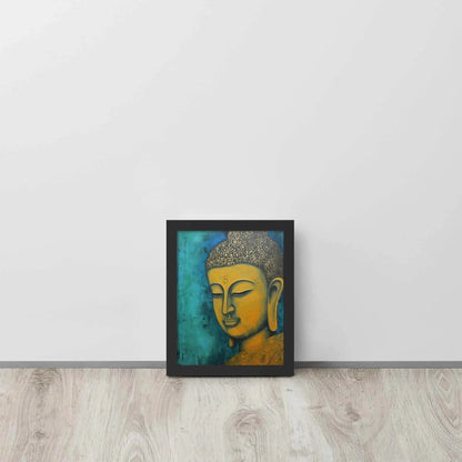 A black oak framed Golden Buddha Painting poster featuring a close-up of a serene Buddha's face with a golden complexion against a textured turquoise background is presented on a light wooden floor beside a white wall, embodying a blend of spirituality and modern art aesthetics.