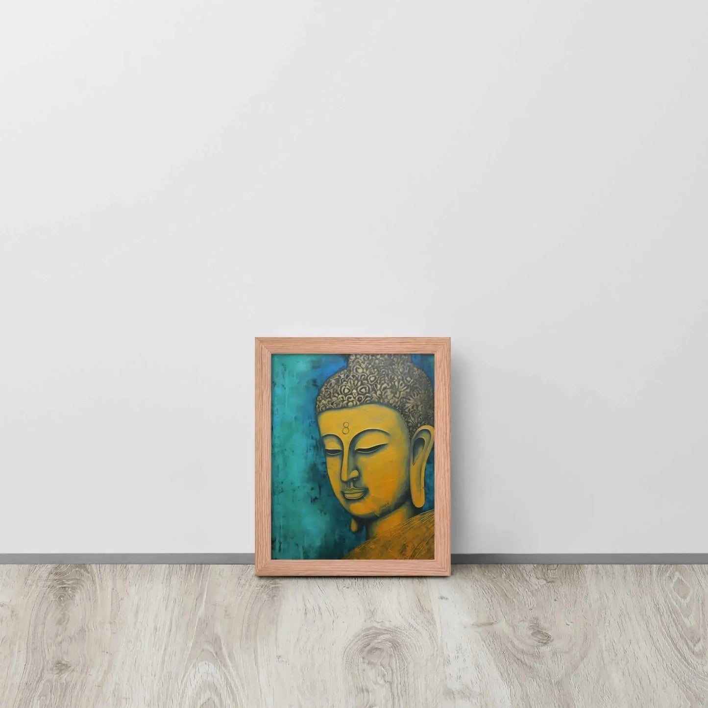 A red oak framed Golden Buddha Painting poster featuring a close-up of a serene Buddha's face with a golden complexion against a textured turquoise background is presented on a light wooden floor beside a white wall, embodying a blend of spirituality and modern art aesthetics.