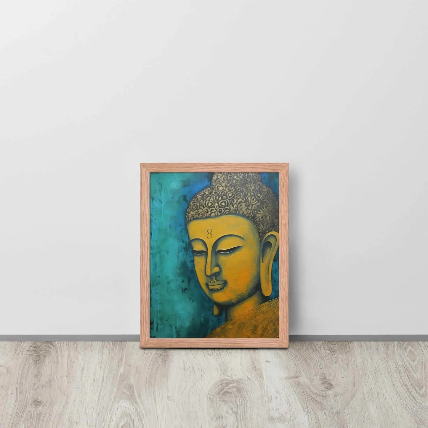 A red oak framed Golden Buddha Painting poster featuring a close-up of a serene Buddha's face with a golden complexion against a textured turquoise background is presented on a light wooden floor beside a white wall, embodying a blend of spirituality and modern art aesthetics.