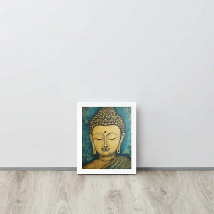 A white oak framed poster on a light wooden floor features a Golden Buddha Zen Wall Art with a tranquil expression, set against an abstract blue textured background, conveying a sense of peace and introspection beside a white wall.