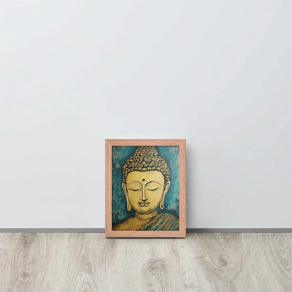 A red oak framed poster on a light wooden floor features a Golden Buddha Zen Wall Art with a tranquil expression, set against an abstract blue textured background, conveying a sense of peace and introspection beside a white wall.