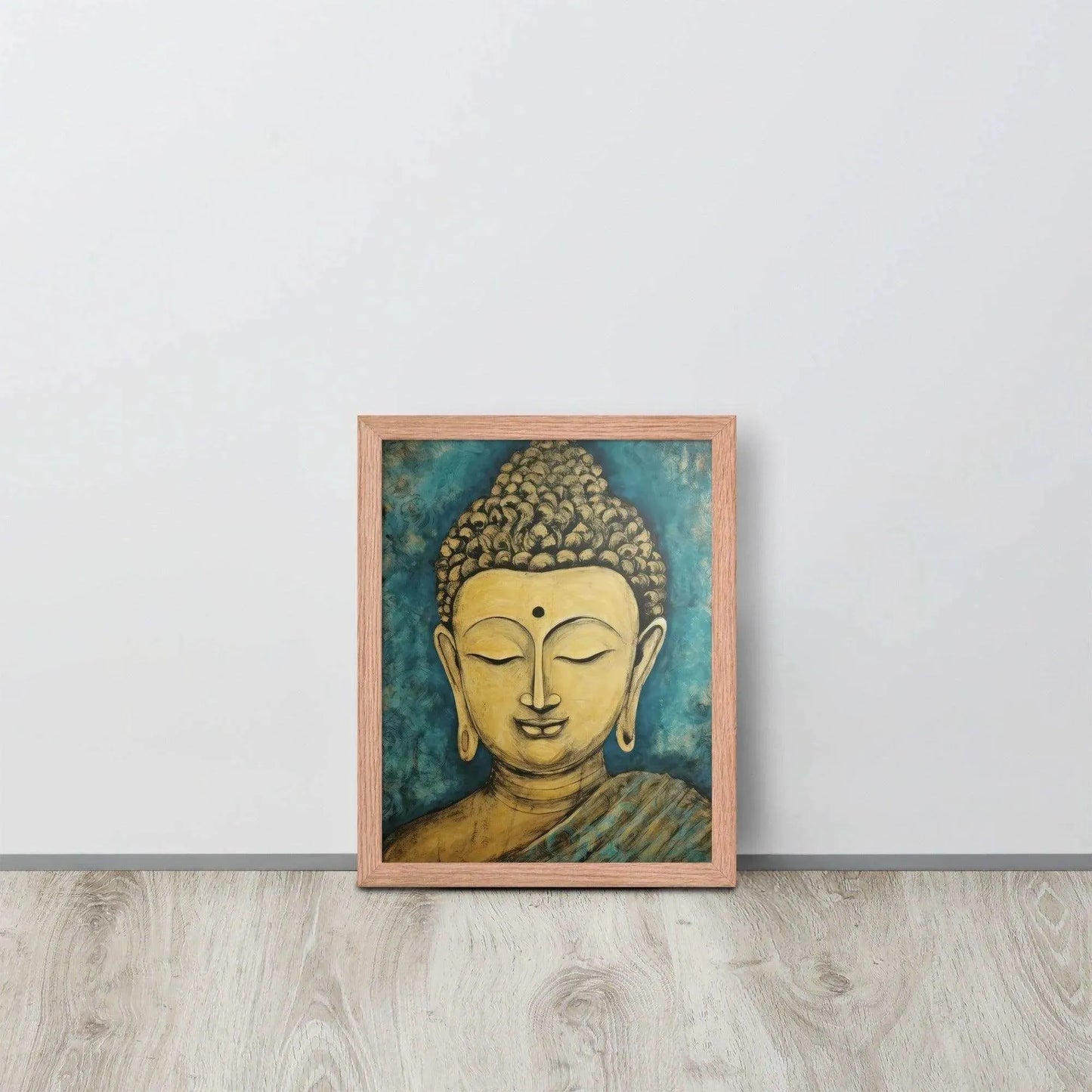 A red oak framed poster on a light wooden floor features a Golden Buddha Zen Wall Art with a tranquil expression, set against an abstract blue textured background, conveying a sense of peace and introspection beside a white wall.