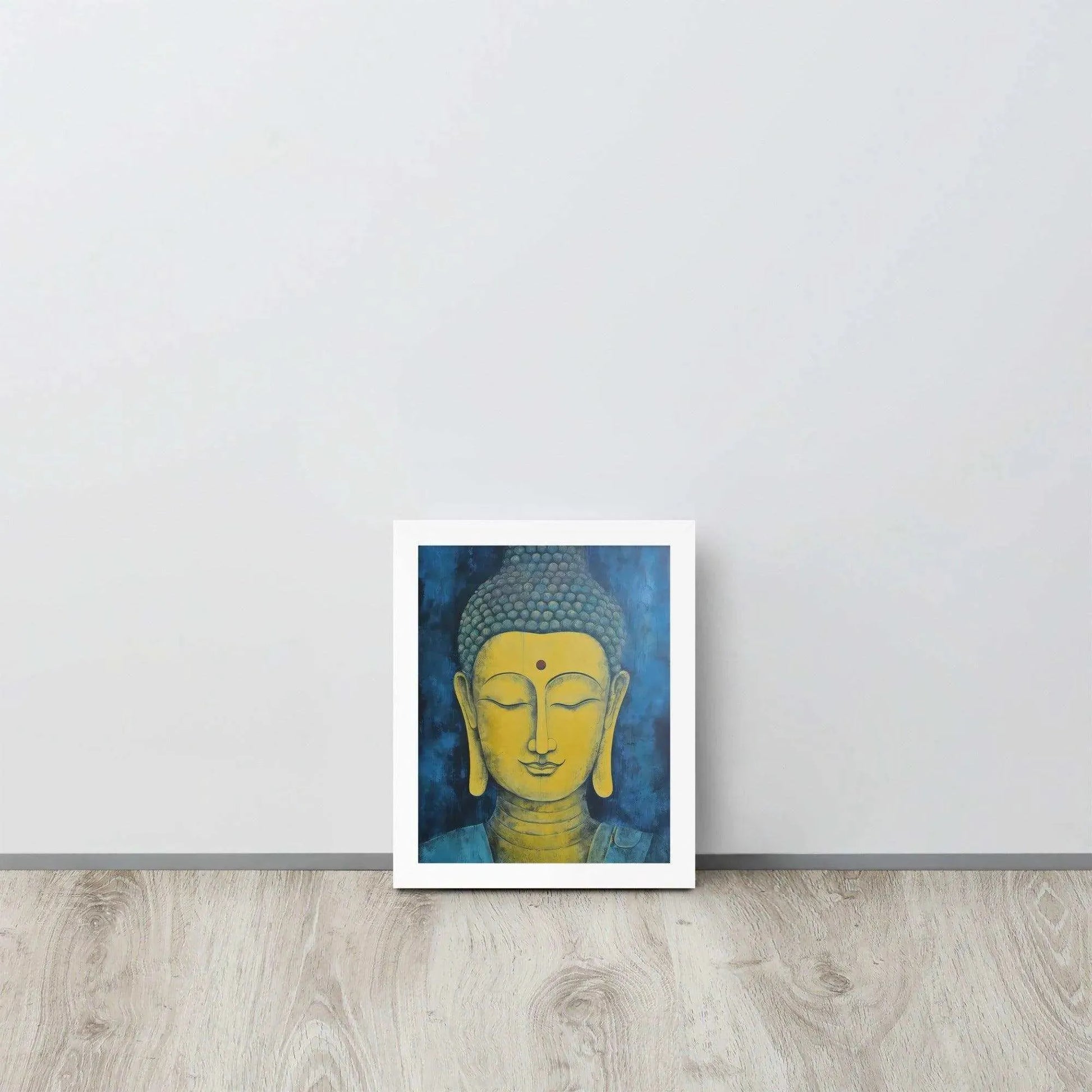 A white-Golden Happy Buddha Framed Print placed on a wooden floor against a white wall features a golden Buddha head with a serene expression, set against a deep blue textured background, creating a focal point of tranquility and spirituality in the room.