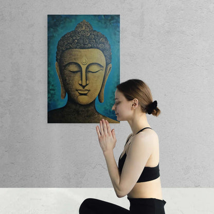 A woman in a yoga pose with hands pressed together in front of a golden Buddha head painting on a textured wall.