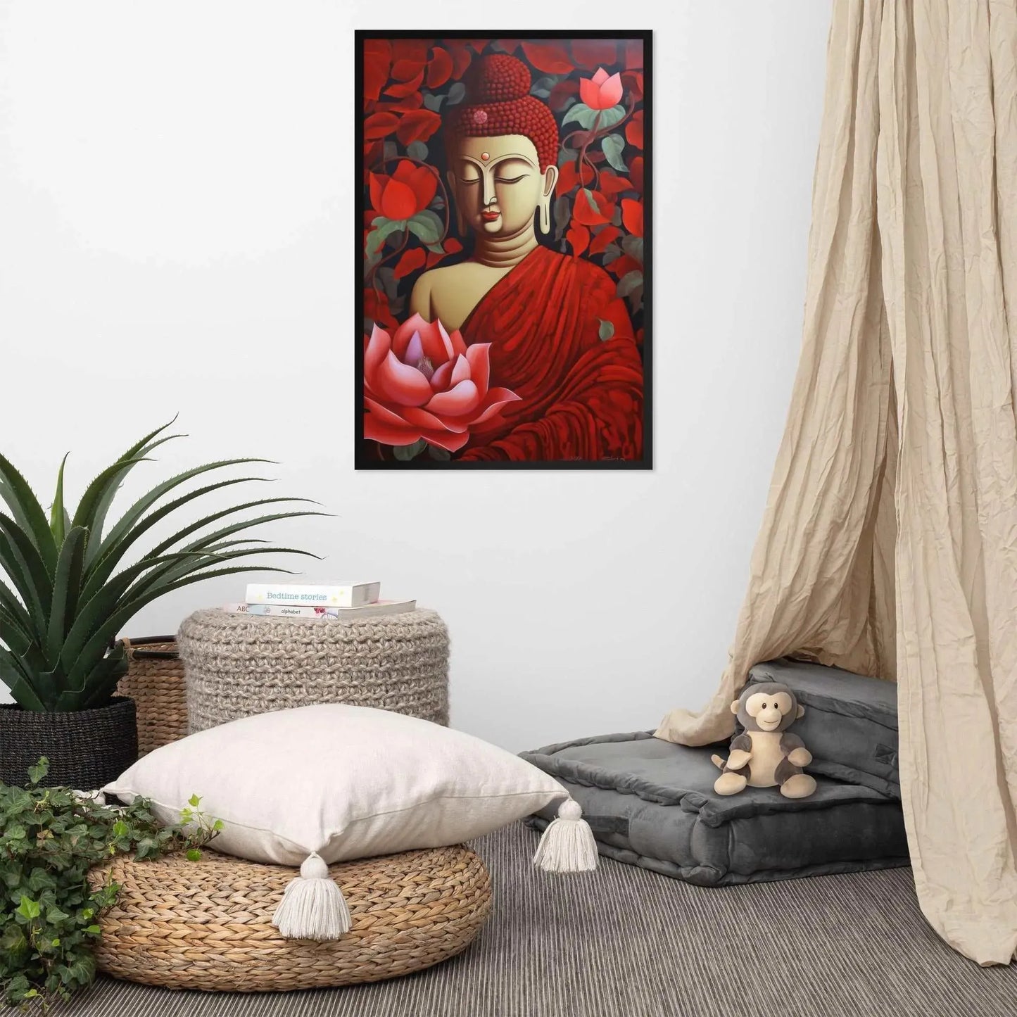 A framed poster of a red Buddha in meditation with a radiant red aura and a large pink lotus flower is set against a backdrop of dark red leaves, creating a peaceful corner in a room with a cozy reading nook, complete with cushions, a woven pouf, and a soft curtain. Nearby, a plush toy monkey adds a touch of playfulness to the tranquil setting.