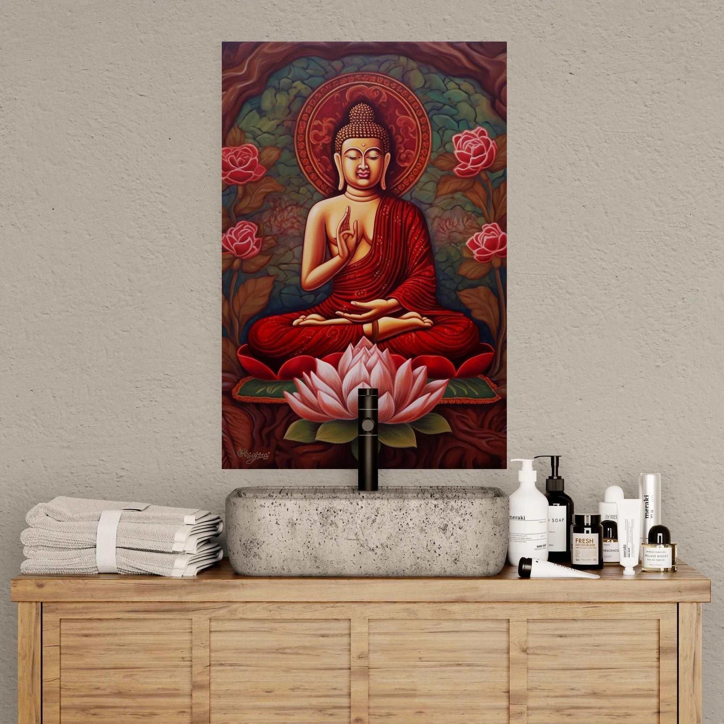 A traditional Buddha painting in rich red and gold tones featuring a seated Buddha and a pink lotus, against a floral backdrop, placed above a wooden console with towels and skincare products.