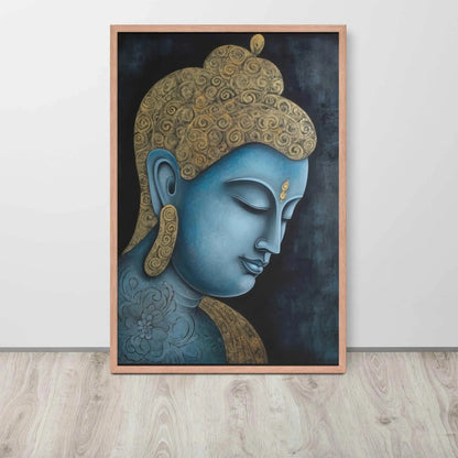 A framed Tibetan Blue Buddha Painting depicts a side profile of a serene, blue-toned Buddha with a golden patterned head, highlighted with a delicate golden ornament on the forehead. The artwork is placed against a dark, smokey background within a red oak frame, resting on a light wooden floor next to a white wall.