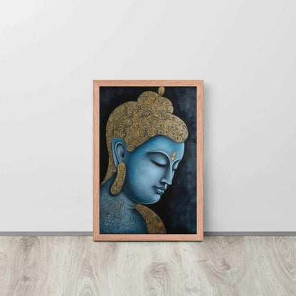 A framed Tibetan Blue Buddha Painting depicts a side profile of a serene, blue-toned Buddha with a golden patterned head, highlighted with a delicate golden ornament on the forehead. The artwork is placed against a dark, smokey background within a red oak frame, resting on a light wooden floor next to a white wall.