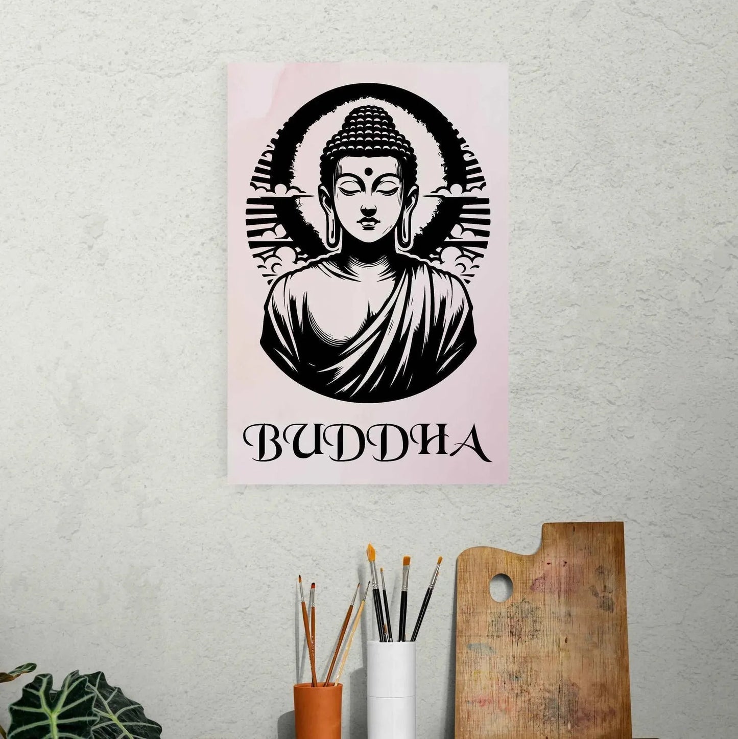 The Timeless Buddha Poster by Printify features a stylized black-and-white image of Buddha with a halo, radiating spiritual serenity. The word "BUDDHA" is beautifully inscribed beneath it. This stunning piece enhances a textured wall above a shelf filled with art supplies and mindful decor.