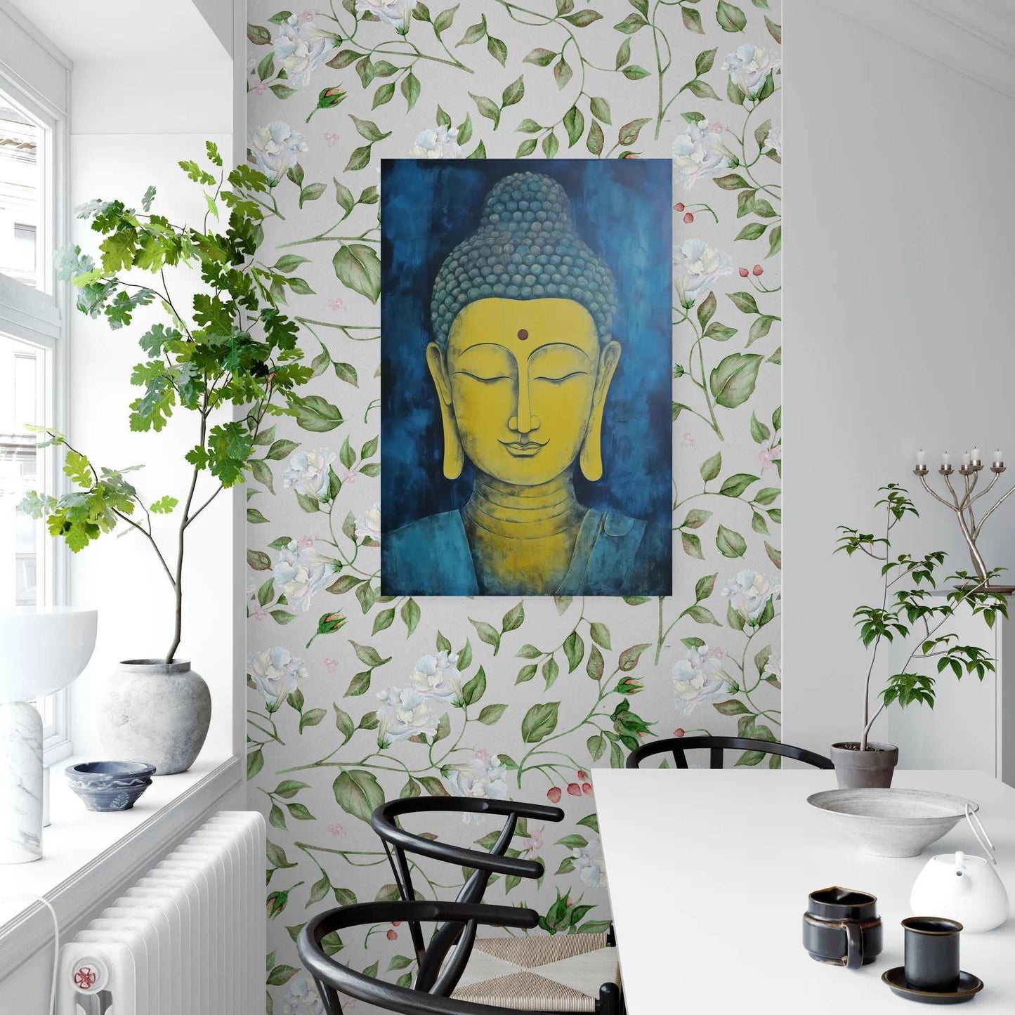Peaceful dining corner with a green plant on a white sill, floral wallpaper, and a blue and gold Buddha head painting on the wall.