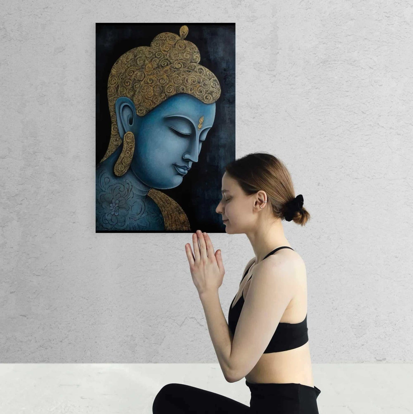 A woman practicing meditation in front of a tranquil blue and gold Buddha painting, promoting a sense of peace and mindfulness.