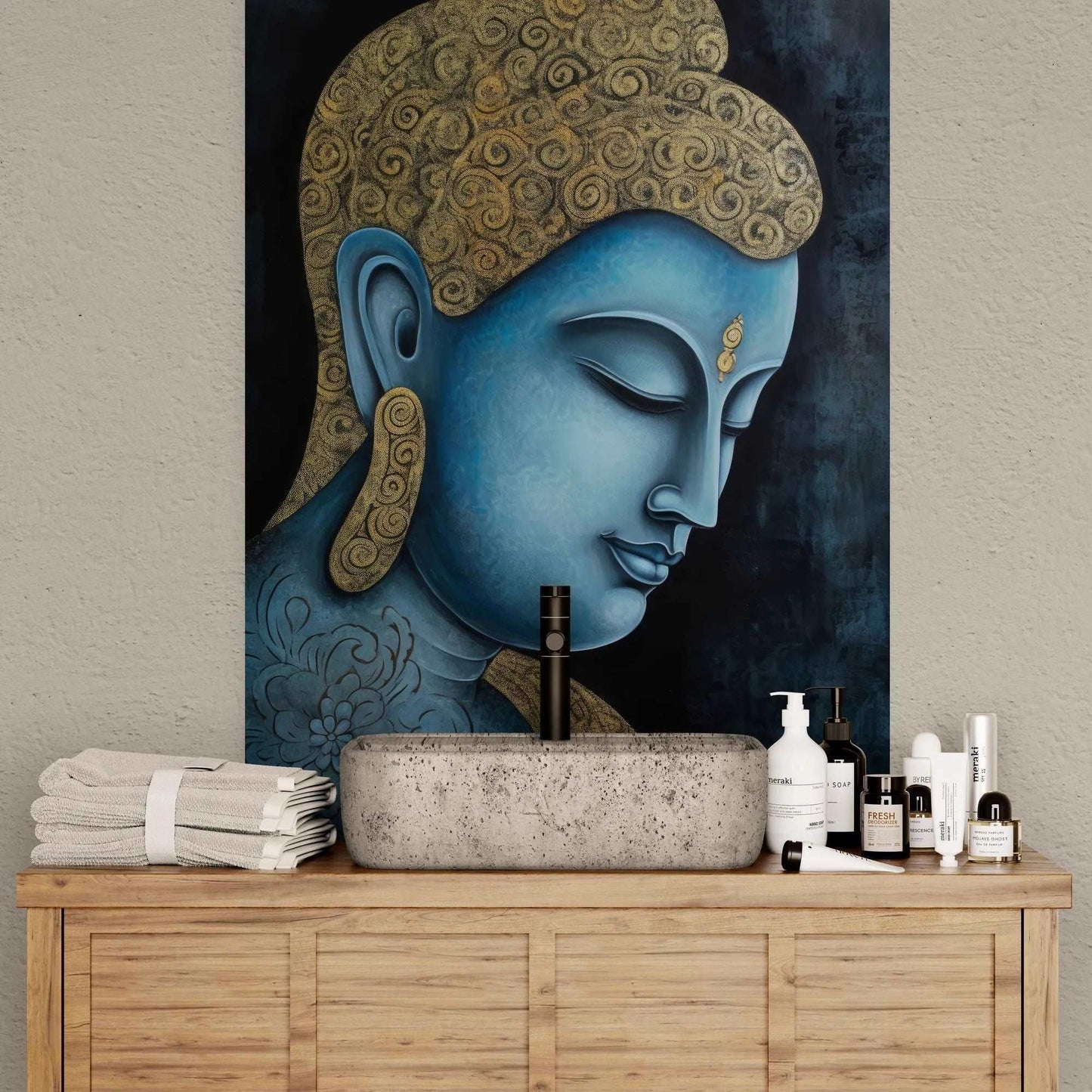 Close-up of a serene blue and gold Buddha painting in a bathroom setting, above a stone sink with neatly folded towels and skincare products.