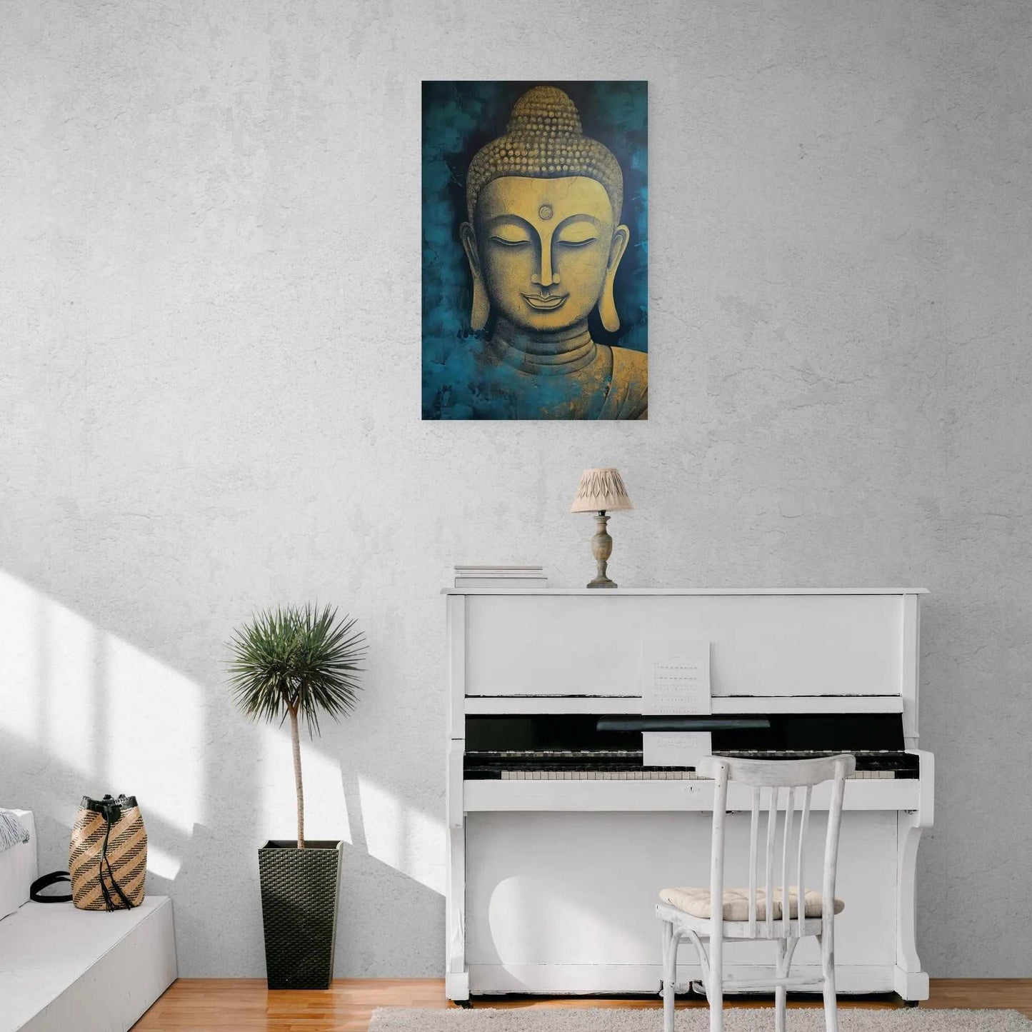 Golden Buddha head canvas displayed above a white piano against a textured wall, with a potted plant and chair beside.