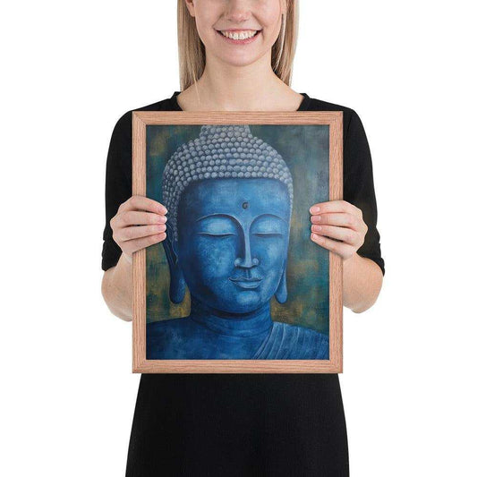 A smiling woman in a black top is displaying a red oak framed poster featuring a serene, monochromatic blue Buddha head with a textured background that adds depth to the peaceful visage.