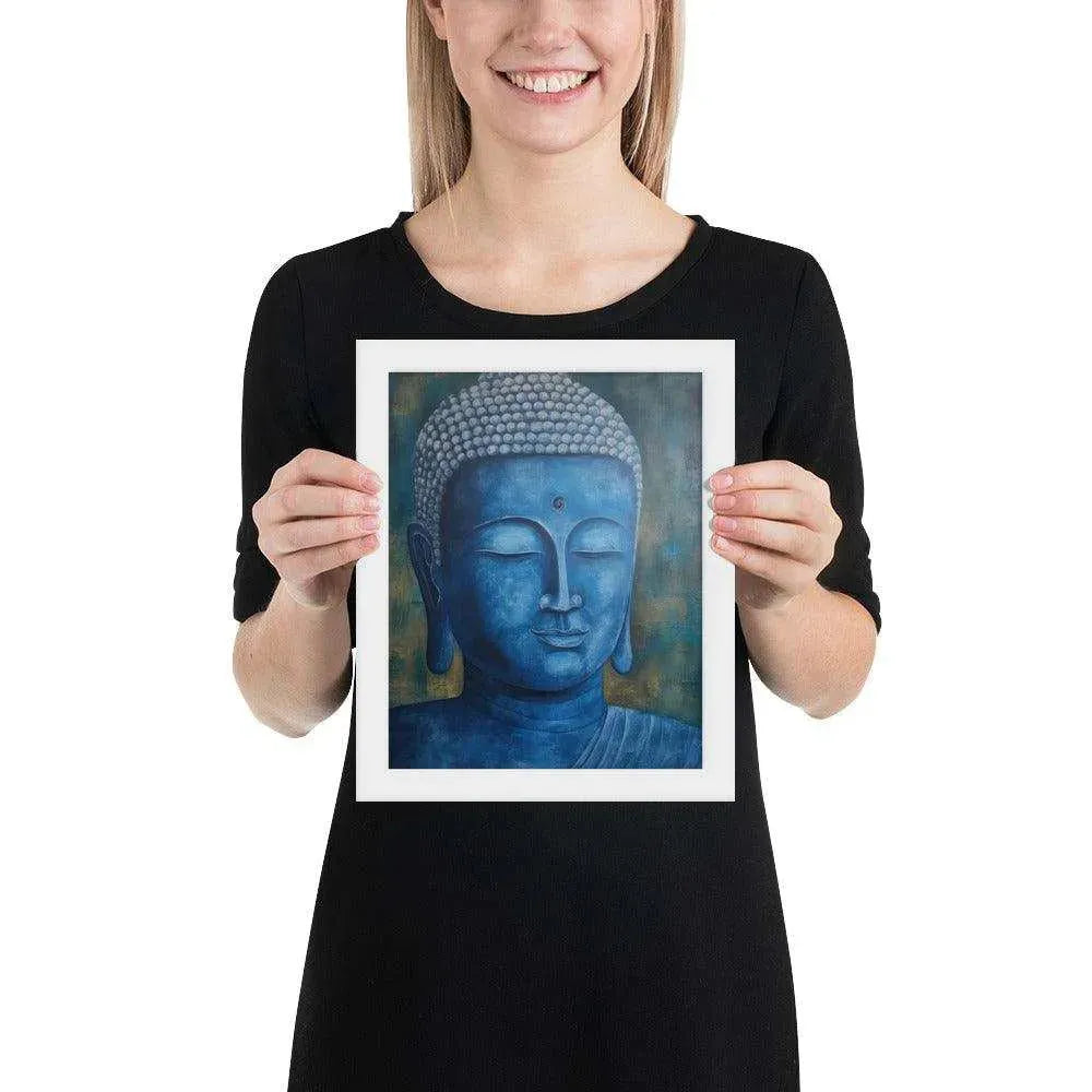 A smiling woman in a white top is displaying a black oak framed poster featuring a serene, monochromatic Blue Buddha Healing Art with a textured background that adds depth to the peaceful visage.