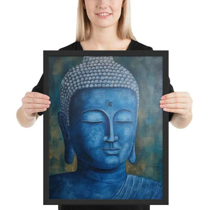 A smiling woman in a black top is displaying a black oak framed poster featuring a serene, monochromatic Blue Buddha Healing Art with a textured background that adds depth to the peaceful visage.