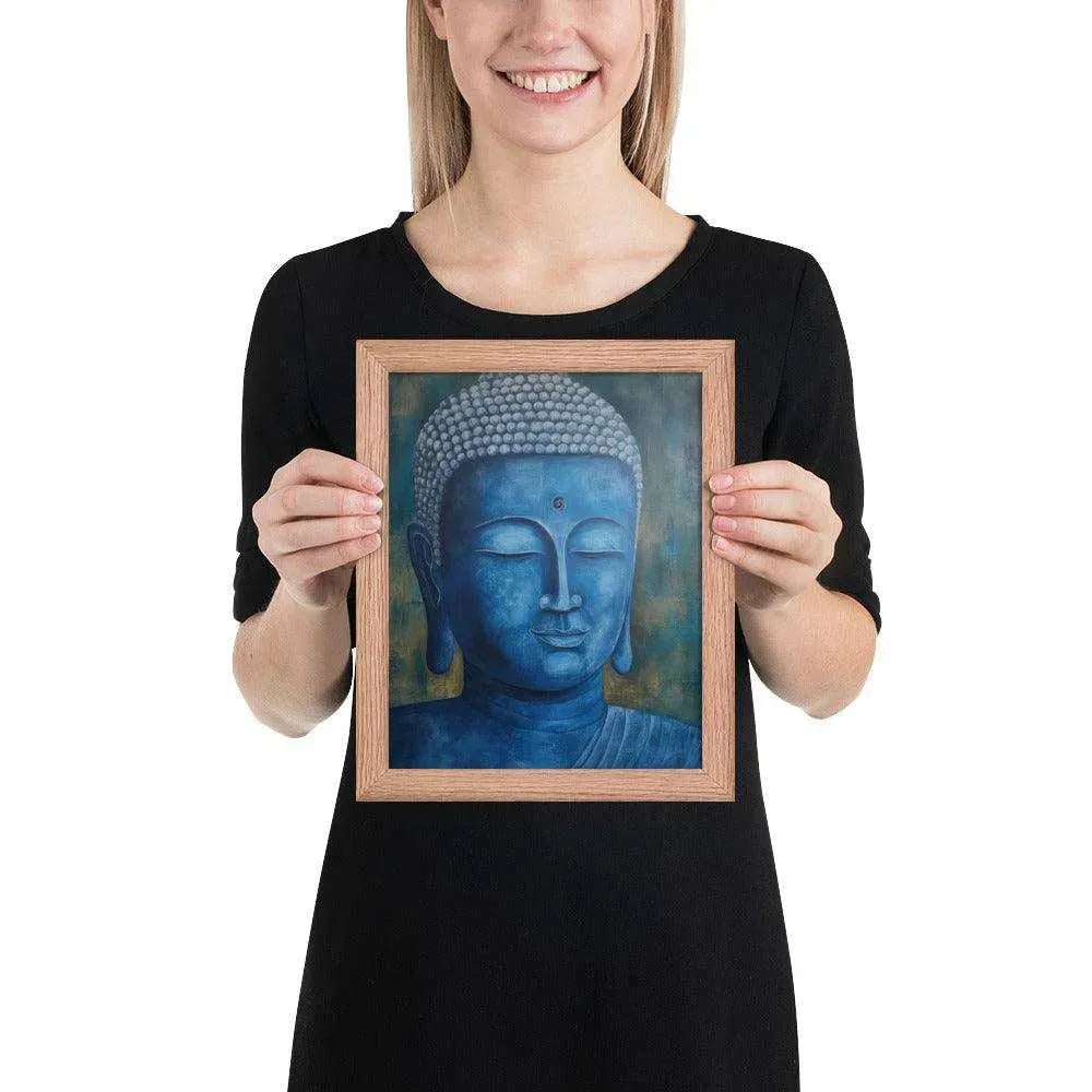 A smiling woman in a black top is displaying a red oak framed poster featuring a serene, monochromatic blue Buddha head with a textured background that adds depth to the peaceful visage.