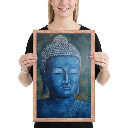 A smiling woman in a black top is displaying a red oak framed poster featuring a serene, monochromatic blue Buddha head with a textured background that adds depth to the peaceful visage.